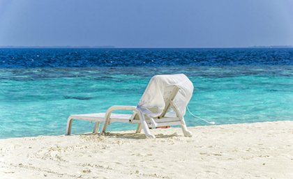 Empty beach chair sitting on a beautiful Queensland beach 